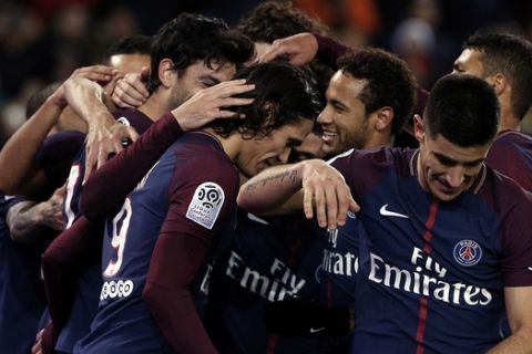 PSG players celebrate after PSG's Javier Pastore, obscured, scored a goal during their French League One soccer match between Paris-Saint-Germain and Nantes, at the Parc des Princes stadium in Paris, France, Saturday, Nov.18, 2017. (AP Photo/Thibault Camus)
