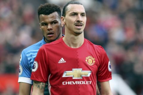 AFC Bournemouth's Tyrone Mings, left, and Manchester United's Zlatan Ibrahimovic during the English Premier League soccer match at Old Trafford, Manchester, England, Saturday March 4, 2017. (Martin Rickett/PA via AP)