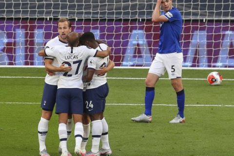 Tottenham players celebrate after scoring the opening goal during the English Premier League soccer match between Tottenham Hotspur and Everton FC at the Tottenham Hotspur Stadium in London, England, Monday, July 6, 2020.(Cath Ivill/Pool via AP)