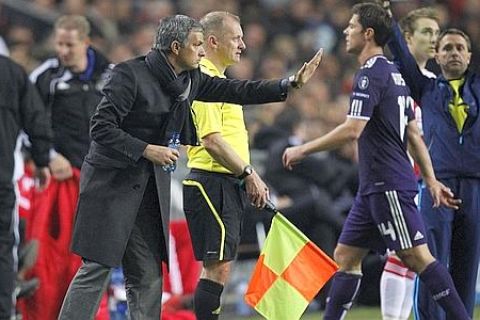 Real Madrid coach Jose Mourinho, left,  gestures as Xabi Alonso, right, walks off the pitch with a red card during the group G Champions League soccer match against Ajax at ArenA stadium in Amsterdam, Netherlands, Tuesday Nov. 23, 2010. Madrid won the match 4-0. (AP Photo/Peter Dejong)