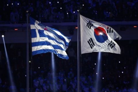 Feb 23, 2014; Sochi, RUSSIA; The Greek (left) and Korean flags fly during the closing ceremony for the Sochi 2014 Olympic Winter Games at Fisht Olympic Stadium. Mandatory Credit: Rob Schumacher-USA TODAY Sports