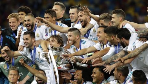 Real Madrid players celebrate with the trophy after winning the Champions League Final soccer match between Real Madrid and Liverpool at the Olimpiyskiy Stadium in Kiev, Ukraine, Saturday, May 26, 2018. (AP Photo/Sergei Grits)