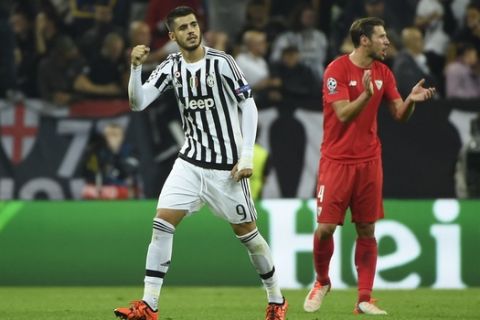 Juventus' forward from Spain Alvaro Morata (L) celebrates after scoring during the UEFA Champions League football match Juventus vs FC Sevilla on September 30 at the Juventus stadium in Turin.  AFP PHOTO / OLIVIER MORIN        (Photo credit should read OLIVIER MORIN/AFP/Getty Images)
