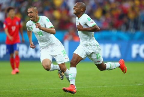 PORTO ALEGRE, BRAZIL - JUNE 22:  Yacine Brahimi of Algeria (R) celebrates scoring his team's fourth goal during the 2014 FIFA World Cup Brazil Group H match between South Korea and Algeria at Estadio Beira-Rio on June 22, 2014 in Porto Alegre, Brazil.  (Photo by Jeff Gross/Getty Images)
