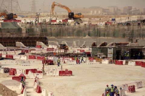 In this photo taken during a government organized media tour, laborers work at the Al-Wakra Stadium that is under construction for the 2022 World Cup, in Doha, Qatar, Monday, May 4, 2015. Qatars top labor official told The Associated Press Monday that Qatars inability to ensure decent housing for its bulging migrant labor population was a mistake the government is working to fix as it prepares to host the 2022 World Cup, vowing his country would improve conditions for its vast foreign labor force. (AP Photo/Maya Alleruzzo)