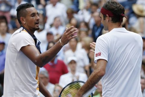 Roger Federer, right, of Switzerland, shakes hands with Nick Kyrgios, of Australia, after Federer defeated Kyrgios during the third round of the U.S. Open tennis tournament, Saturday, Sept. 1, 2018, in New York. (AP Photo/Jason DeCrow)