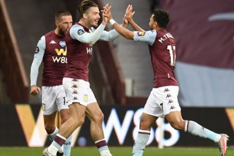 Aston Villa's Trezeguet, right, celebrates with teammate Jack Grealish after scoring his team's first goal during the English Premier League soccer match between Aston Villa and Arsenal at Villa Park in Birmingham, England, Tuesday, July 21, 2020. (AP Photo/Peter Powell,Pool)
