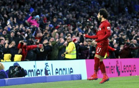 Liverpool's Mohamed Salah celebrates scoring his side's first goal of the game during the English Premier League soccer match between Brighton and Hove Albion and Liverpool F.C at the Vitality Stadium, Brighton England. Saturday, Jan. 12, 2019. (Gareth Fuller/PA via AP)