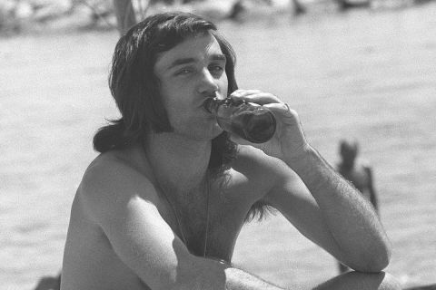 Former Manchester United and Northern Ireland footballer George Best sits on the beach at Marbella, Spain, May 25, 1972, after announcing his retirement from football. (AP Photo)