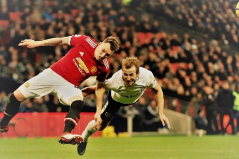 Manchester United's Phil Jones and Tottenham's Harry Kane jump to head the ball during the English Premier League soccer match between Tottenham Hotspur and Manchester United at Wembley stadium, in London, Wednesday Jan. 31, 2018. (AP Photo/Alastair Grant)