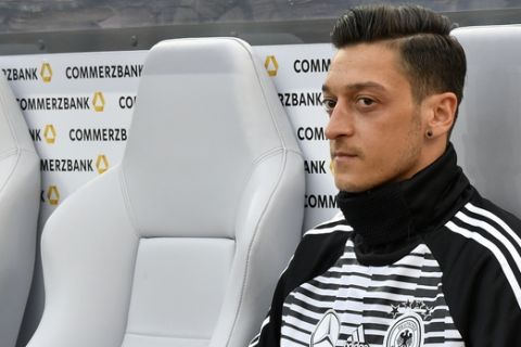 Germany's Mesut Ozil looks out from the bench prior to the start of a friendly soccer match between Germany and Saudi Arabia at BayArena in Leverkusen, Germany, Friday, June 8, 2018. (AP Photo/Martin Meissner)