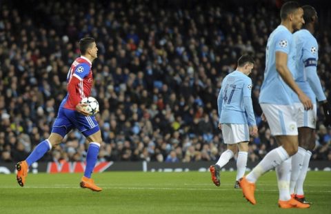 Basel's Mohamed Elyounoussi, left, celebrates after scoring his side's opening goal during the Champions League, round of 16, second leg soccer match between Manchester City and Basel at the Etihad Stadium in Manchester, England, Wednesday, March 7, 2018. (AP Photo/Rui Vieira)