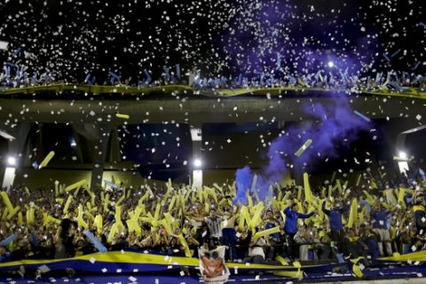 Fans of Boca Juniors cheer amid confetti during the Copa Libertadores semifinal second leg soccer match against River Plate at La Bombonera stadium in Buenos Aires, Argentina, Tuesday, Oct. 22, 2019. (AP Photo/Natacha Pisarenko)