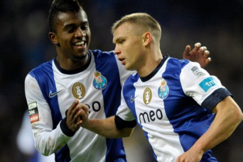 Porto's Russian midfielder Marat Izmaylov (R) is congratulated by teammate Brazilian midfielder Kelvin Oliveira after scoring a goal during the Portuguese league football match FC Porto vs Pacos Ferreira at the Dragao stadium in Porto on January 19, 2013.  AFP PHOTO/ MIGUEL RIOPA        (Photo credit should read MIGUEL RIOPA/AFP/Getty Images)