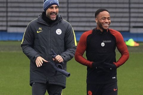 Manchester City manager Pep Guardiola, left,  shares a joke with Raheem Sterling  during a training session at the City Football Academy, in Manchester, England, Tuesday March 14, 2017. Manchester City will play Monaco in a second leg Champions League Round of 16 soccer match on Wednesday. (Peter Byrne/ PA via AP)