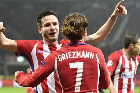 Atletico's Antoine Griezmann, front, is congratulated by his teammate Saul Niguez after scoring their side's second goal during the Champions League round of 16 first leg soccer match between Bayer Leverkusen and Atletico Madrid in Leverkusen, Germany, Tuesday, Feb. 21, 2017. (AP Photo/Martin Meissner)