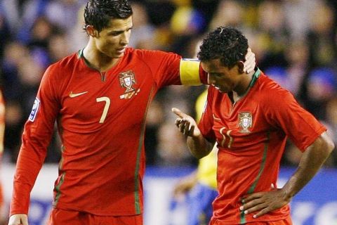 Portugal's Cristiano Ronaldo (L) talks to teammate Nani after he was brought down by a hard tackle during their World Cup 2010 qualifying soccer match against Sweden at Rasunda Stadium in Stockholm October 11, 2008.  REUTERS/Bob Strong (SWEDEN)