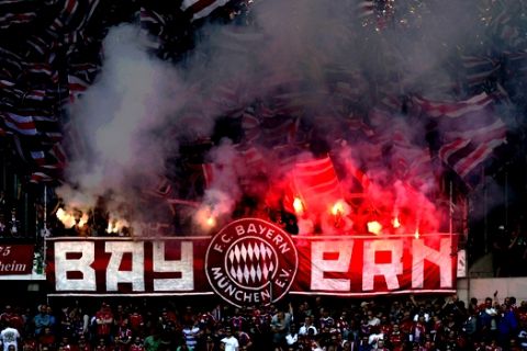 Bayern fans light flares during a German Bundesliga soccer match between Hannover 96 and Bayern Munich in Hannover, Germany, Saturday, April 21, 2018. (Peter Steffen/dpa via AP)