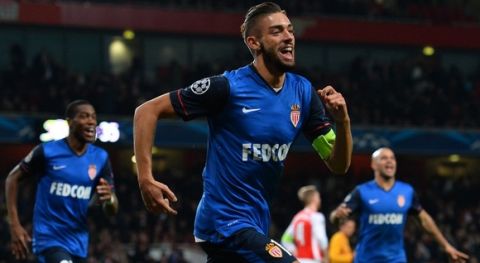 Monaco's Belgian midfielder Yannick Ferreira Carrasco (C) celebrates scoring his team's third goal during the UEFA Champions League round of 16 first leg football match between Arsenal and Monaco at the Emirates Stadium in London on February 25, 2015.  AFP PHOTO / GLYN KIRK        (Photo credit should read GLYN KIRK/AFP/Getty Images)
