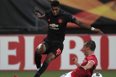 Manchester United's Marcus Rashford is tackled by Alkmaar's Stijn Wuytens during the group L Europa League soccer match between AZ Alkmaar and Manchester United at the ADO Den Haag stadium in The Hague, Netherlands, Thursday, Oct. 3, 2019. (AP Photo/Peter Dejong)