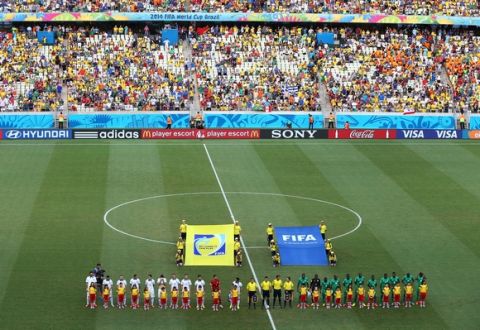 FORTALEZA, BRAZIL - JUNE 24: Greece and the Ivory Coast line up for the National Anthems prior to the 2014 FIFA World Cup Brazil Group C match between Greece and the Ivory Coast at Castelao on June 24, 2014 in Fortaleza, Brazil.  (Photo by Robert Cianflone/Getty Images)