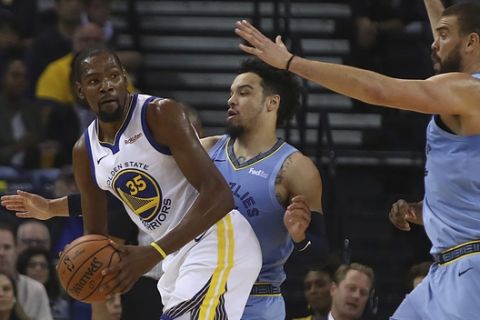 Golden State Warriors' Kevin Durant, left, looks to pass away from Memphis Grizzlies' Dillon Brooks, center, and Marc Gasol, right, during the first half of an NBA basketball game Monday, Nov. 5, 2018, in Oakland, Calif. (AP Photo/Ben Margot)