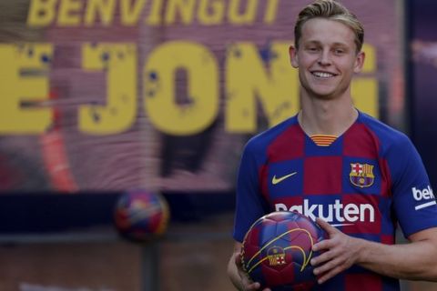 Dutch soccer player Frenkie de Jong poses for media and supporters as he is unveiled as an FC Barcelona player at the Camp Nou stadium in Barcelona, Spain, Friday, July 5, 2019. (AP Photo/Emilio Morenatti)