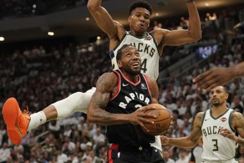 Toronto Raptors' Kawhi Leonard tries to shoot in front of Milwaukee Bucks' Giannis Antetokounmpo during the second half of Game 1 of the NBA Eastern Conference basketball playoff finals Wednesday, May 15, 2019, in Milwaukee. The Bucks won 108-100 to take a 1-0 lead in the series. (AP Photo/Morry Gash)
