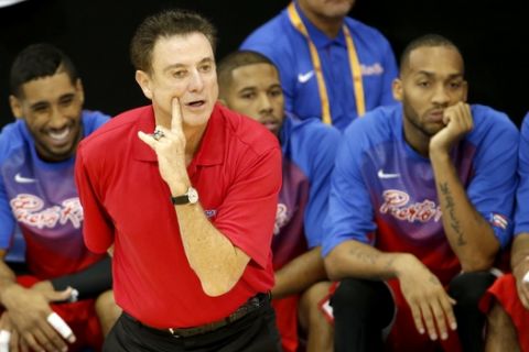 FILE - In this July 21, 2015, file photo, Puerto Rico head coach Richard Pitino talks to his team during the third quarter of a men's basketball game against Brazil at the Pan Am Games in Toronto. Pitino's loyalties will be divided this week as the Louisville coach guides Puerto Rico's national teams in nine exhibition games against his Cardinals, who will be coached by his assistants. (AP Photo/Julio Cortez, File)