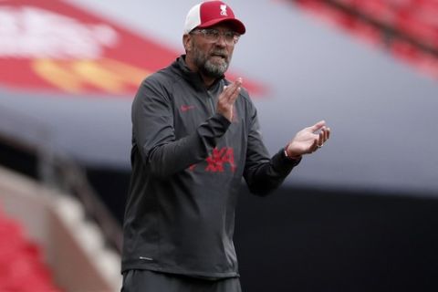 Liverpool manager Jurgen Klopp gives instructions to his players during the English FA Community Shield soccer match between Arsenal and Liverpool at Wembley stadium in London, Saturday, Aug. 29, 2020. (Andrew Couldridge/Pool via AP)