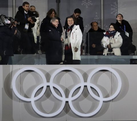 International Olympic Committee President Thomas Bach, left, shakes hands with South Korean President Moon Jae-in as his wife Kim Jung-sook stands second from right near Kim Yo Jong, far right, sister of North Korean leader Kim Jong Un, and Kim Yong Nam, North Korea's nominal head of state, third from right, during the opening ceremony of the 2018 Winter Olympics in Pyeongchang, South Korea, Friday, Feb. 9, 2018. (AP Photo/Petr David Josek)