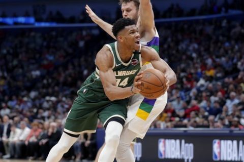 Milwaukee Bucks forward Giannis Antetokounmpo (34) drives to the basket against New Orleans Pelicans forward Nicolo Melli in the second half of an NBA basketball game in New Orleans, Tuesday, Feb. 4, 2020. The Bucks won 120-108. (AP Photo/Gerald Herbert)