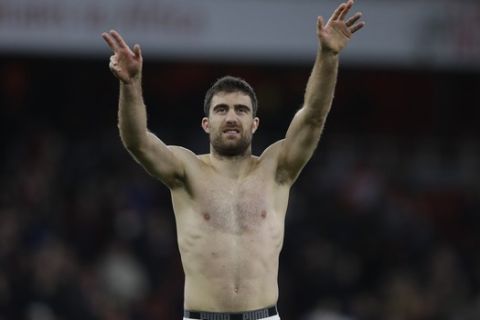 Arsenal's Sokratis Papastathopoulos celebrates at the end of the English Premier League soccer match between Arsenal and Fulham at Emirates stadium in London, Tuesday, Jan. 1, 2019. (AP Photo/Kirsty Wigglesworth)