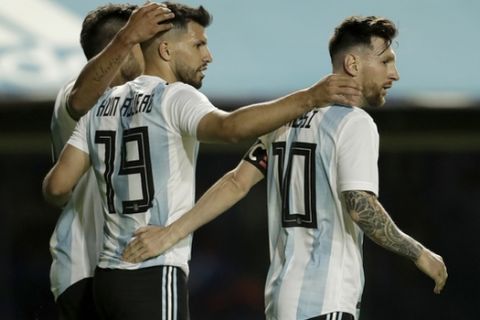 Argentina's Lionel Messi is congratulated by teammates Sergio Aguero and Eduardo Salvio after he scored during a friendly soccer match between Argentina and Haiti in Buenos Aires, Argentina, Tuesday, May 29, 2018. (AP Photo/Victor R. Caivano)