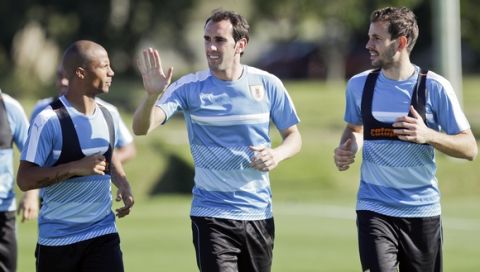 Uruguay's Carlos Sanchez, left, Diego Godin, center, and Christian Stuani, right run during a training session of the national soccer team in the outskirts of Montevideo, Uruguay, Monday, March 20, 2017. Uruguay will face Brazil in a 2018 World Cup qualifying soccer match in Montevideo on March 23. (AP Photo/Matilde Campodonico)