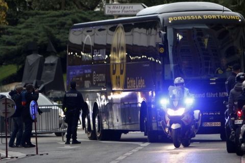 The team bus of German Bundesliga soccer club is escorted by police officers as it arrives at the Louis stadium before the Champions League quarterfinal second leg soccer match between Monaco and Dortmund in Monaco, Wednesday April 19, 2017. (AP Photo/Claude Paris)