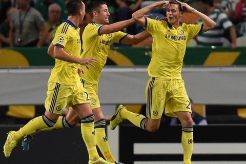 Chelsea's Serbian midfielder Nemanja Matic (R) celebrates after scoring during the UEFA Champions League Group G football match Sporting CP vs Chelsea FC at Alvalade XXI stadium in Lisbon on September 30, 2014.  AFP PHOTO / FRANCISCO LEONG        (Photo credit should read FRANCISCO LEONG/AFP/Getty Images)
