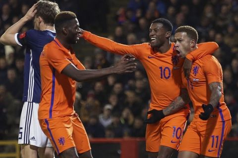Netherlands Memphis Depay, right, celebrates scoring his side's first goal of the game with team-mates during the International Friendly match at Pittodrie in Aberdeen, Scotland, Thursday Nov. 9, 2017. (Andrew Milligan/PA via AP)