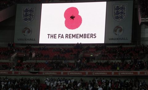 FILE - In this Saturday, Nov. 12, 2011 file photo, a poppy is displayed on a big screen for Armistice Day before the international friendly soccer match between England and Spain at Wembley Stadium in London. England and Scotland will face FIFA sanctions after insisting their players will wear black armbands with embroidered poppies to honor Britain's war dead for a match between the neighbors. England and Scotland will meet for a World Cup qualifier on Nov. 11, 2016, Britain's Remembrance Day, when British Commonwealth forces who have died on duty since World War I are honored. (AP Photo/Kirsty Wigglesworth, file)
