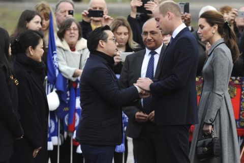 Aiyawatt Srivaddhanaprabha, the son of Vichai Srivaddhanaprabha, meets Britain's Prince William and Kate, Duchess and Duke of Cambridge, right, during a visit to pay their tribute to those who were tragically killed in a helicopter crash, at Leicester City Football Club's King Power Stadium in Leicester, England, Wednesday, Nov. 28, 2018. Vichai Srivaddhanaprabha, the Thai billionaire owner of Premier League team Leicester City was among five people who died after his helicopter crashed and burst into flames shortly after taking off from the soccer field on Saturday Oct. 27, 2018. (AP Photo/Rui Vieira)