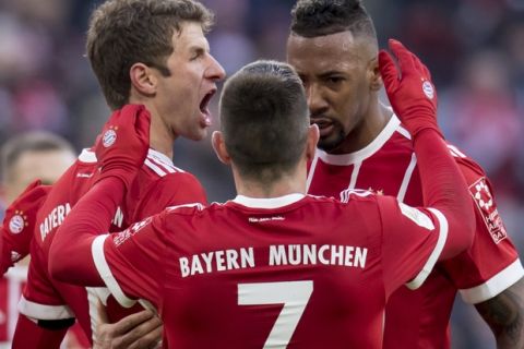 Munich's scorer Thomas Mueller, Franck Ribery and Jerome Boateng, from left celebrate after their side's first goal during the German first division Bundesliga soccer match between Bayern Munich and Werder Bremen in the Allianz Arena in Munich, Germany, Sunday, Jan. 21, 2018. (Sven Hoppe/dpa via AP) via AP)