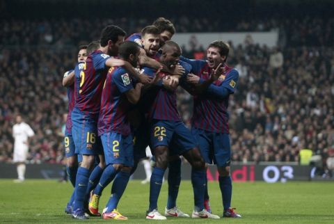 Barcelona's Eric Abidal (2nd R) is congratulated by team mates after scoring against Real Madrid during their Spanish King's Cup quarter-final first leg "El Clasico" soccer match at the Santiago Bernabeu stadium in Madrid, January 18, 2012.     REUTERS/Stringer (SPAIN - Tags: SPORT SOCCER)