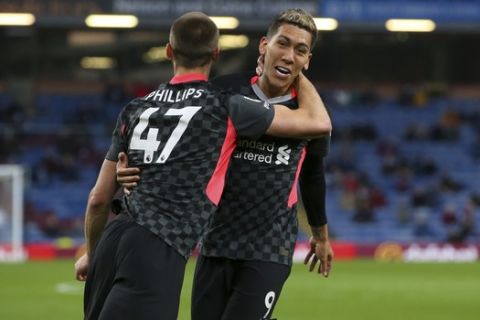 Liverpool's Nathaniel Phillips, left, celebrates with Liverpool's Roberto Firmino after scoring his side's second goal during the English Premier League soccer match between Burnley and Liverpool at Turf Moor in Burnley, England, Wednesday May 19, 2021. (Alex Livesey/Pool via AP)