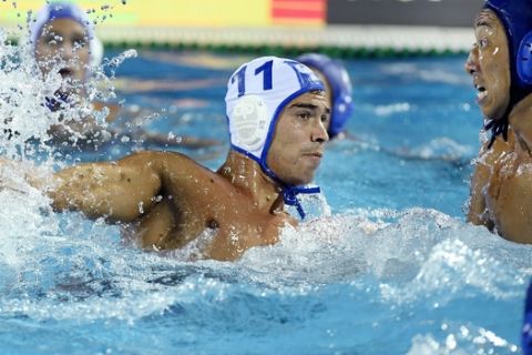 Alexandros Gounas, center, of Greece and Mitsuaki Shiga of Japan in action, during the men's water polo match for qualifying in the group of eight best teams of the 17th FINA Swimming World Championships in Hajos Alfred National Swimming Pool in Budapest, Hungary, Sunday, July 23, 2017. (Szilard Koszticsak/MTI via AP)