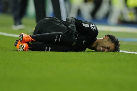 PSG's Neymar lies on the pitch after being fouled during the Champions League soccer match, round of 16, 1st leg between Real Madrid and Paris Saint Germain at the Santiago Bernabeu stadium in Madrid, Spain, Wednesday, Feb. 14, 2018. (AP Photo/Paul White)