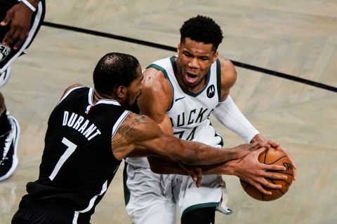 Brooklyn Nets' Kevin Durant (7) defends against Milwaukee Bucks' Giannis Antetokounmpo during the second half of Game 7 of a second-round NBA basketball playoff series Saturday, June 19, 2021, in New York. (AP Photo/Frank Franklin II)