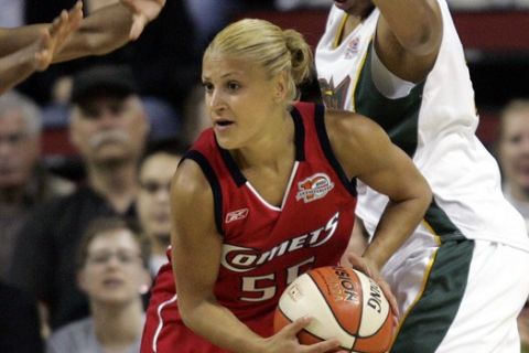 Houston Comets' Anastasia Kostaki, center, of Greece, is defended by Seattle Storm's Kaayla Chones, left, and Tanisha Wright in the first quarter, during a WNBA basketball game, Tuesday, May 23, 2006, in Seattle. (AP Photo/Elaine Thompson)