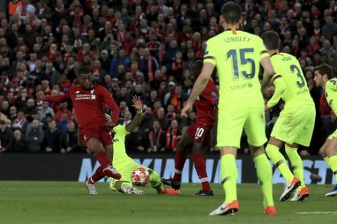 Liverpool's Georginio Wijnaldum scores his side's second goal of the game  during the Champions League Semi Final, second leg soccer match between Liverpool and Barcelona at Anfield, Liverpool, England, Tuesday, May 7, 2019. (Peter Byrne/PA via AP)