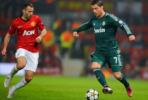 Real Madrid's Portuguese forward Cristiano Ronaldo (R) is challenegd by Manchester United's Welsh midfielder Ryan Giggs (L) during the UEFA Champions League round of 16 second leg football match between Manchester United and Real Madrid at Old Trafford in Manchester, northwest England on March 5, 2013. AFP PHOTO / ANDREW YATES        (Photo credit should read ANDREW YATES/AFP/Getty Images)
