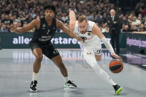 Real Madrid's Dzanan Musa, right, drives to the basket as Partizan's Zach Leday tries to block him during the Euroleague basketball match between Partizan and Real Madrid, in Belgrade, Serbia, Thursday, May 4, 2023. (AP Photo/Darko Vojinovic)